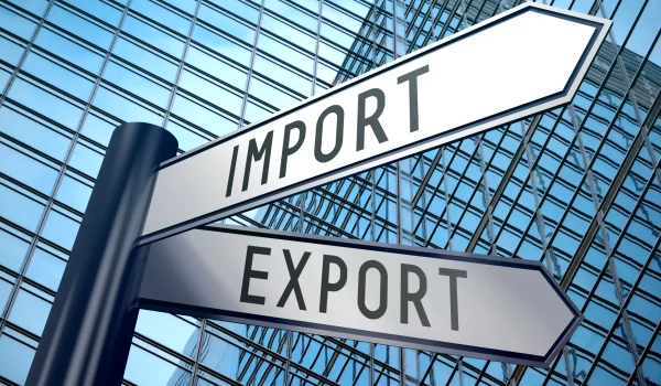 export-import-signpost-with-two-arrows-office-building-background